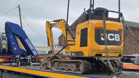 A digger on a low-loader recovered by Kent Police