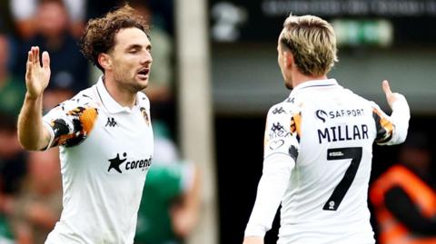 Liam Millar and goalscorer Lewie Coyle celebrate Hull City's equaliser against Plymouth Argyle