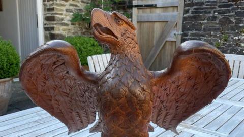A picture of a lecturn which is shaped like an eagle.