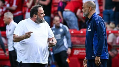 Nottingham Forest's former manager Nuno Espirito Santo speaks with Evangelos Marinakis on the pitch