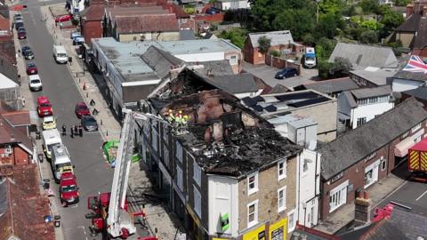 Aerial view of terrace in Petersfield town centre the roof across the terrace is burnt out.