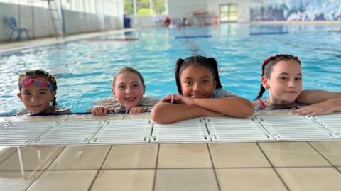 Four children in the leisure centre pool