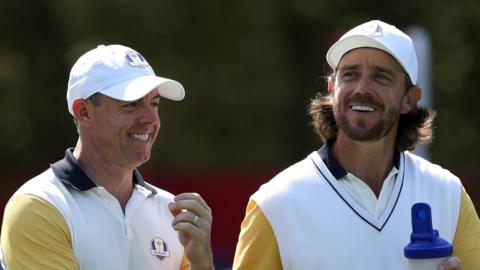 Rory McIlroy and Tommy Fleetwood smile during their Ryder Cup practice rounds