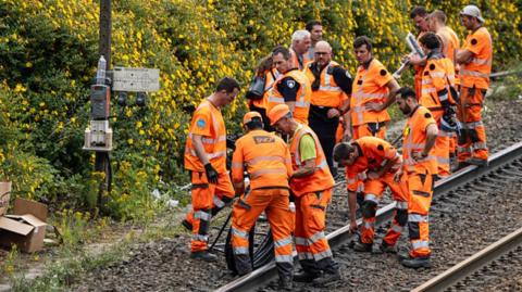 echnicians of French railway company SNCF work to reconnect railway cables at the Mont-de-Terre train station in Lille, northern France on June 25, 2025. 
