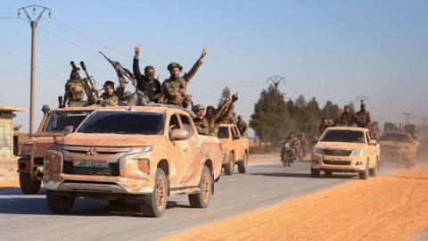 Anti government groups drive a convoy near eastern Aleppo