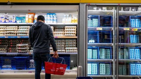 Man looking at eggs in US supermarket