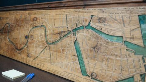 A carved wooden map showing the location of seed-crushing mills along the banks of the River Hull