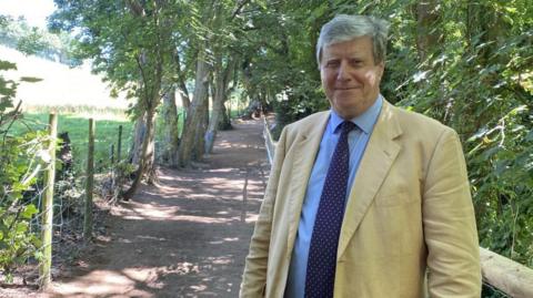 Kevin Lewis standing beside the restored path