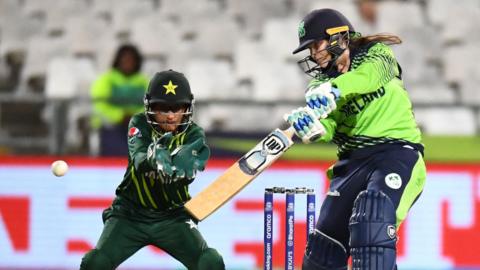 Ireland's Cara Murray hits out, watched by Pakistan wicketkeeper Muneeba Ali, in 2023