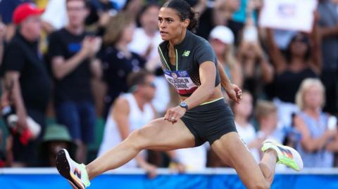 Sydney McLaughlin-Levrone jumping over a hurdle