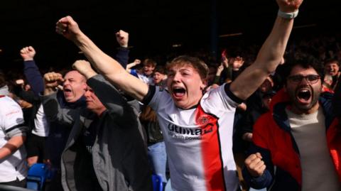 Football supporters celebrating a goal