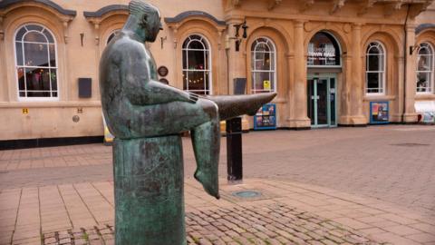 The Sock Man statue outside Loughborough Town Hall