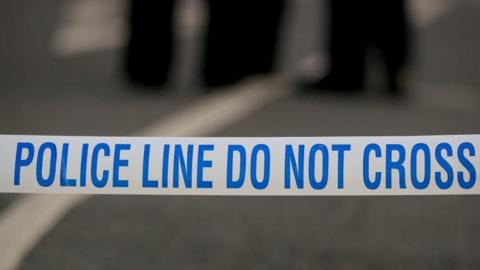 Police tape on an empty street - this is a stock image