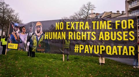 Amnesty International outside the Qatari embassy on International Migrants Day, in Brussels