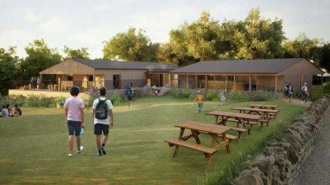 A computer-generated image of a timber clad golf clubhouse surrounded by trees and a lawn on a summer evening. There are people using the outdoor space, which has benches and is surrounded by a Cotswold stone-style wall.