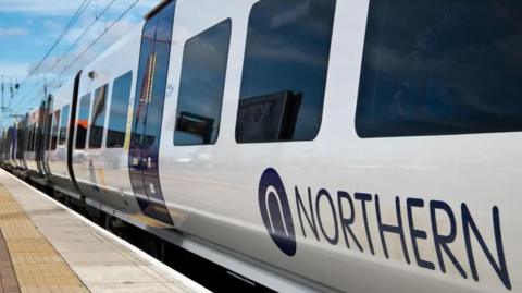 Northern train on a platform at a railway station