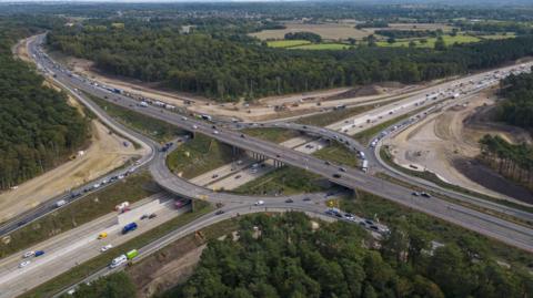 An aerial shot of the Wisley interchange. It is a large roundabout connecting the M25 and A3