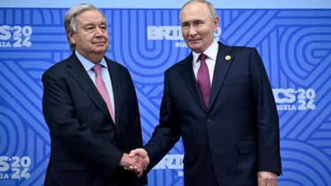 UN Secretary General António Guterres (left) shakes hands with Russian President Vladimir Putin in Kazan on 24 October 2024