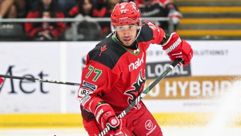 Bayley Harewood skates during a game in the red jersey of Cardiff Devils