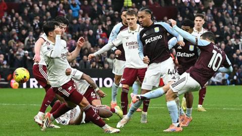 Emiliano Buendia (R) scores