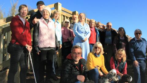 A group of people by Fen Bridge in Suffolk