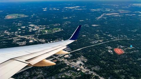 A view from a plane window looking over Atlanta and a sunset sky