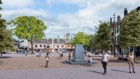 Artist impression of what Market Square will look like following the regeneration project. A grey stone monument stands in the middle of a brick plaza.
