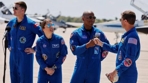 Artemis astronaut team giving fist bumps