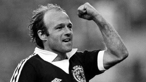 A black and white image of Archie Gemmill celebrating with a fist pump after his famous goal against Netherlands in 1978