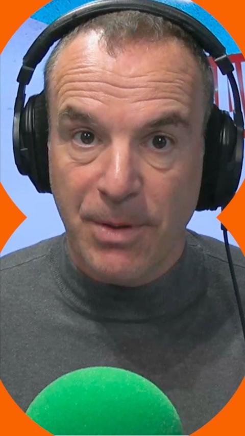 Martin Lewis wearing a grey polo neck and headphones