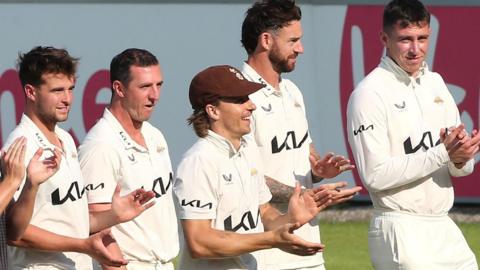 Surrey players clap