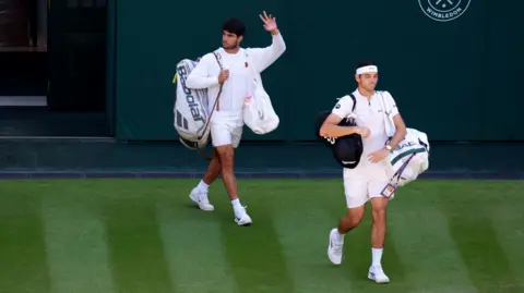 Carlos Alcaraz and Taylor Fritz walk out on to Centre Court