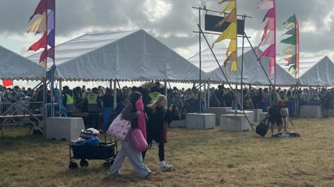 Crowds arriving under tents
