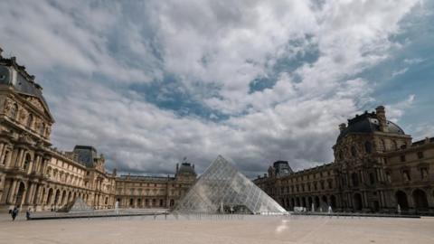 Image shows the exterior of the Louvre