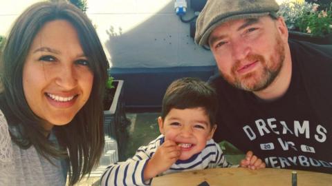 Rosea and Craig Poynter sitting with their son Freddie. 