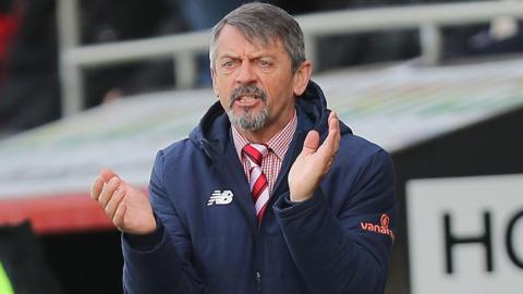 Kidderminster Harriers manager Phil Brown claps his hands in encouragement during a match