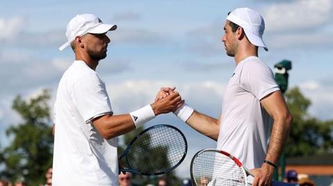 Julian Cash and Lloyd Glasspool shake hands