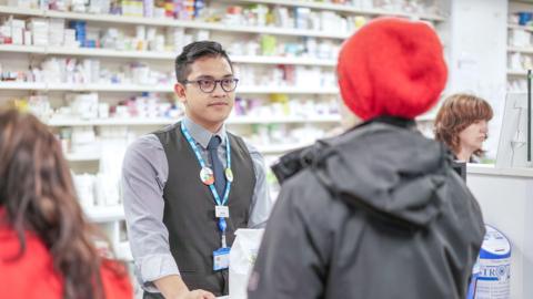 Pharmacist at counter