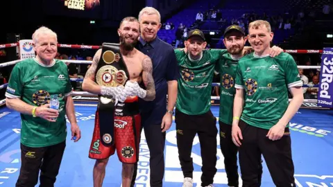 Anthony Cacace with coaches Michael Hawkins Sr and Jr, Barry O'Neill, Ruairi Dalton and manager Simon Legg