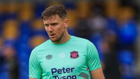Charlie Wyke, with no.10 on his chest, warming up for a Carlisle United match last season 