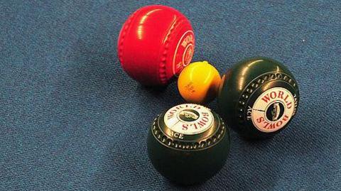 Indoor bowling mat with bowls and a jack