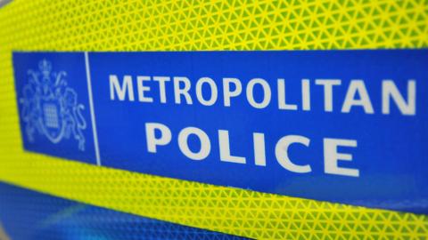 A close up of a Metropolitan Police sign on the side of vehicle. 