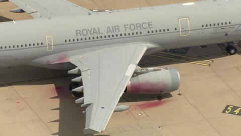 An aerial view of a Royal Air Force plane which has had red paint sprayed onto it.