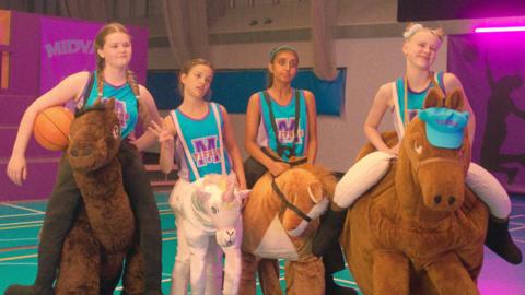 High Hoops basketball players wearing horse mascot costumes