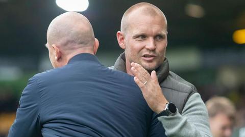 Liam Manning embraces Bristol City's Gerhard Struber at the final whistle