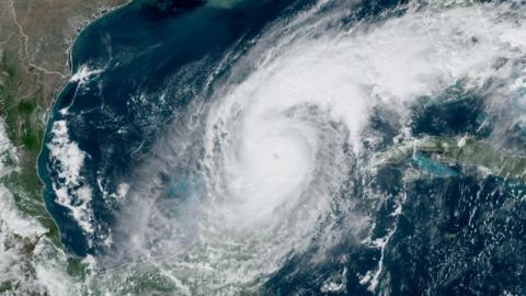 A satellite image which shows a swirl of white cloud - Hurricane Milton - in the Gulf of Mexico