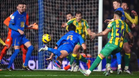 Paik Seung-Ho dives to head towards goal