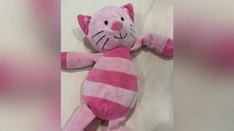 A pink cat toy, which has dark and light pink stripes