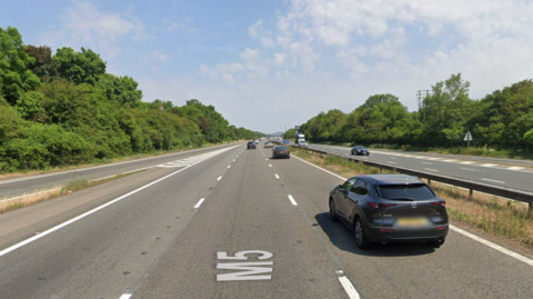 A stock image of the M5 northbound carriageway in Somerset. Vehicles can be seen on the road.