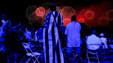People watch a fireworks display that is attempting the largest firework display in history with 850,000 fireworks 